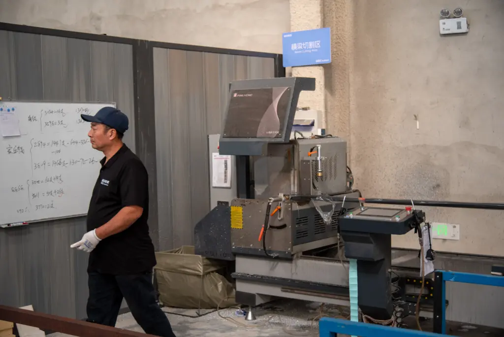 Employee operating production equipment at the GEC pergola factory